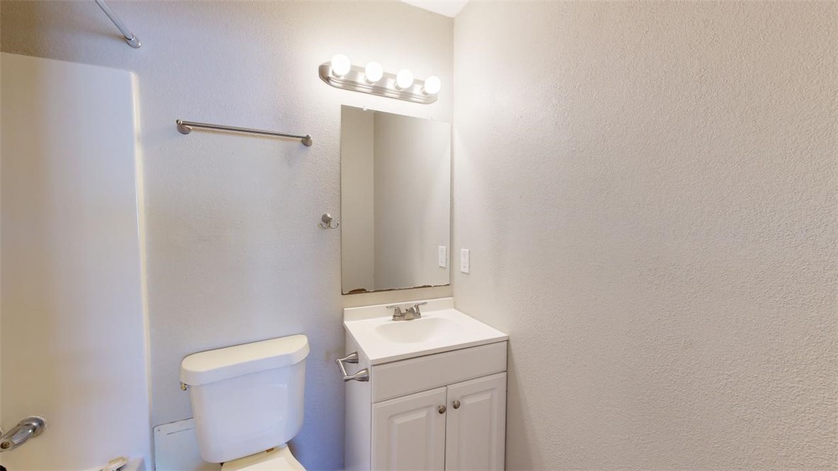 500 Foch Street, Unit 7 Bryan, TX 77801 - Photo 7 of 11 a bathroom with a sink a toilet and a mirror