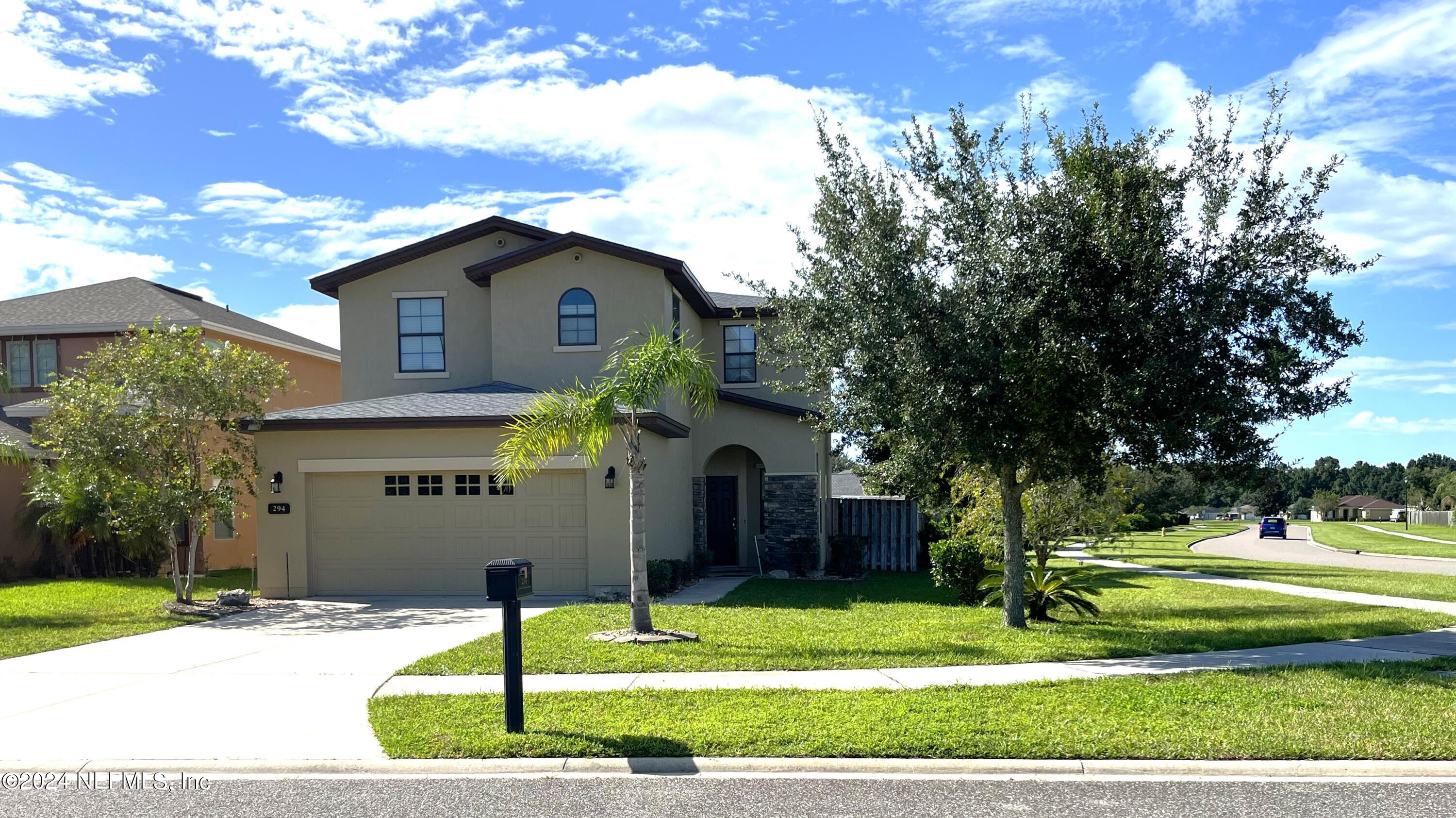 a front view of a house with a yard