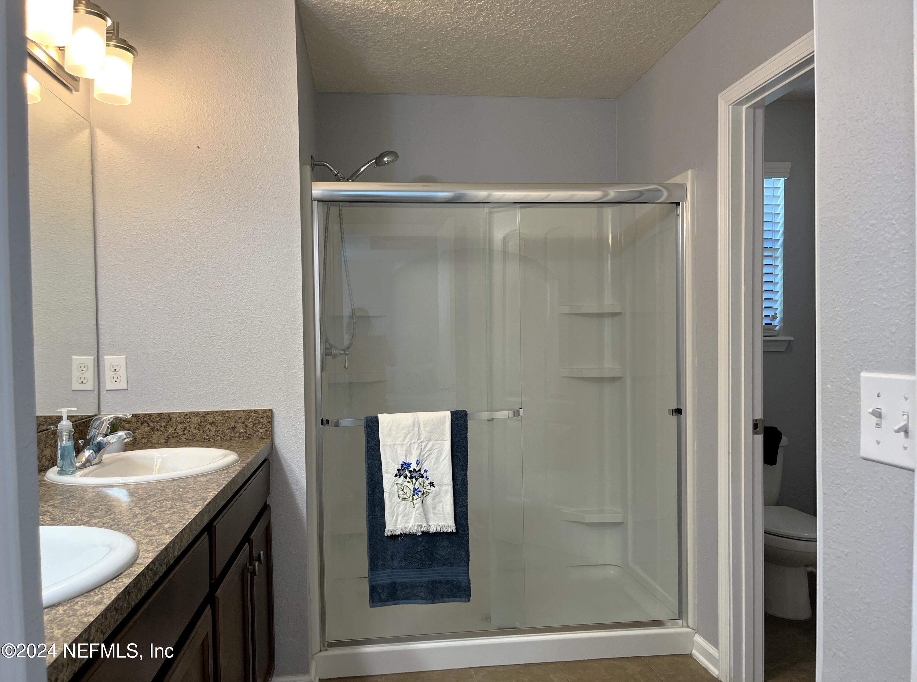 294 Buck Run Way St. Augustine, FL 32092 - Photo 11 of 22 a bathroom with a granite countertop sink shower and a mirror