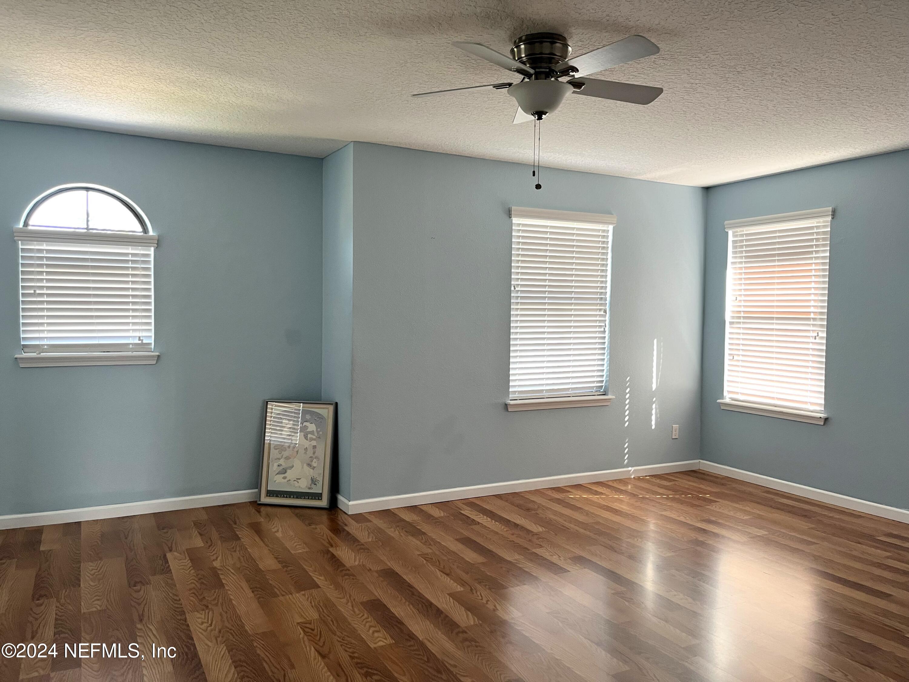 294 Buck Run Way St. Augustine, FL 32092 - Photo 13 of 22 a view of empty room with wooden floor and fan