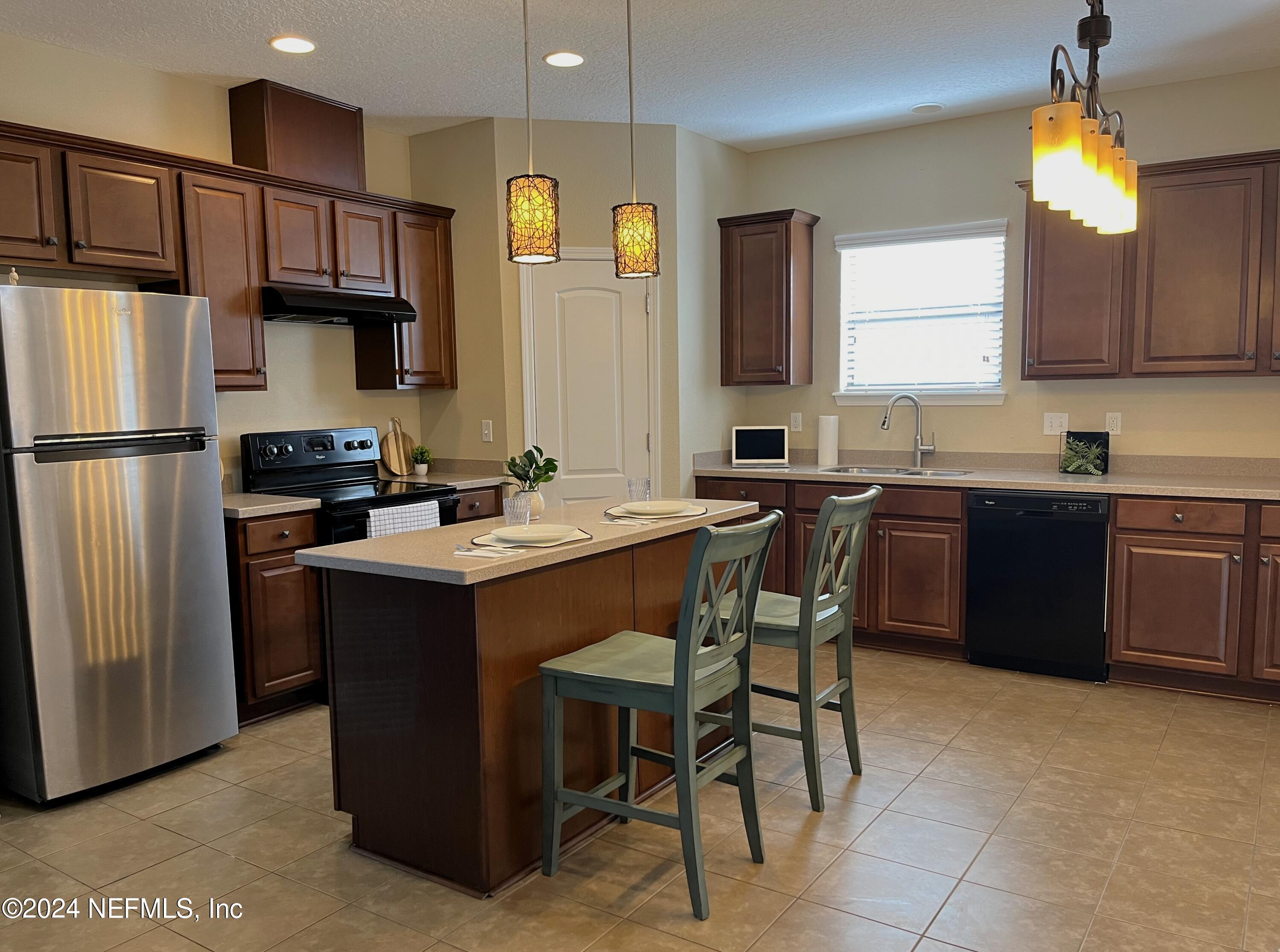 294 Buck Run Way St. Augustine, FL 32092 - Photo 4 of 22 a kitchen with a sink refrigerator and cabinets