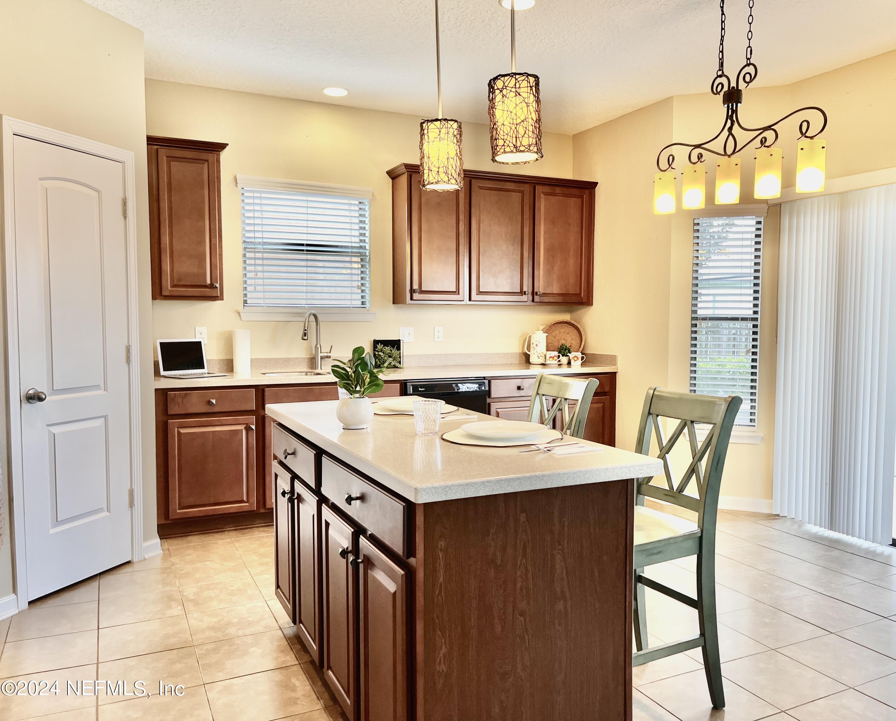 294 Buck Run Way St. Augustine, FL 32092 - Photo 6 of 22 a kitchen with a sink a counter top space and stainless steel appliances
