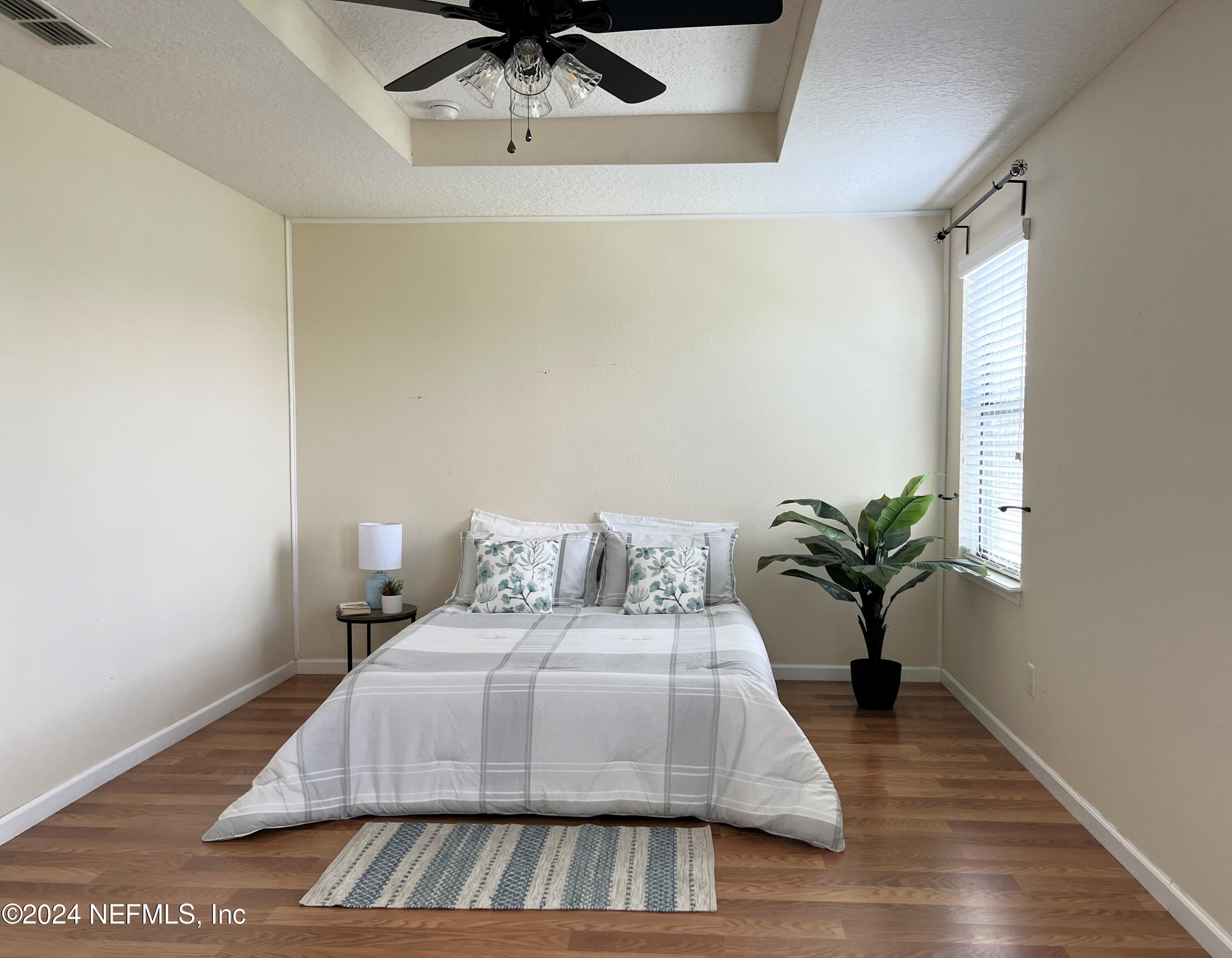 294 Buck Run Way St. Augustine, FL 32092 - Photo 10 of 22 a living room with a bed furniture and a potted plant