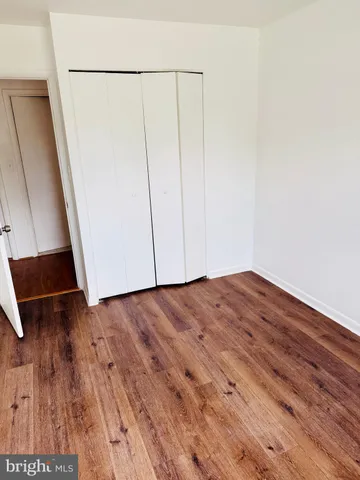 an empty room with wooden floor
