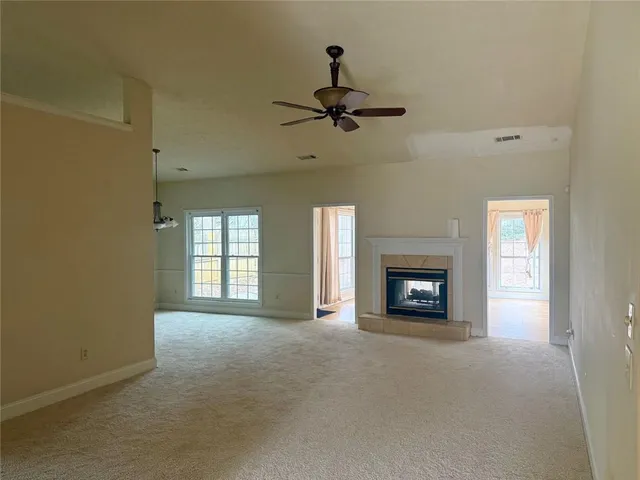 a view of a livingroom with a fireplace and window