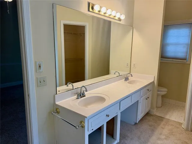 a bathroom with a double vanity sink and a mirror