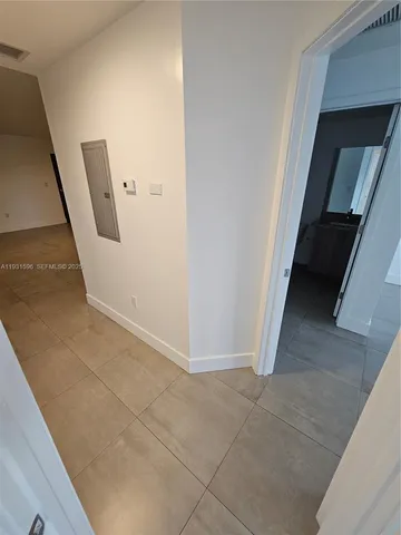 a view of a hallway to rooms and stairs