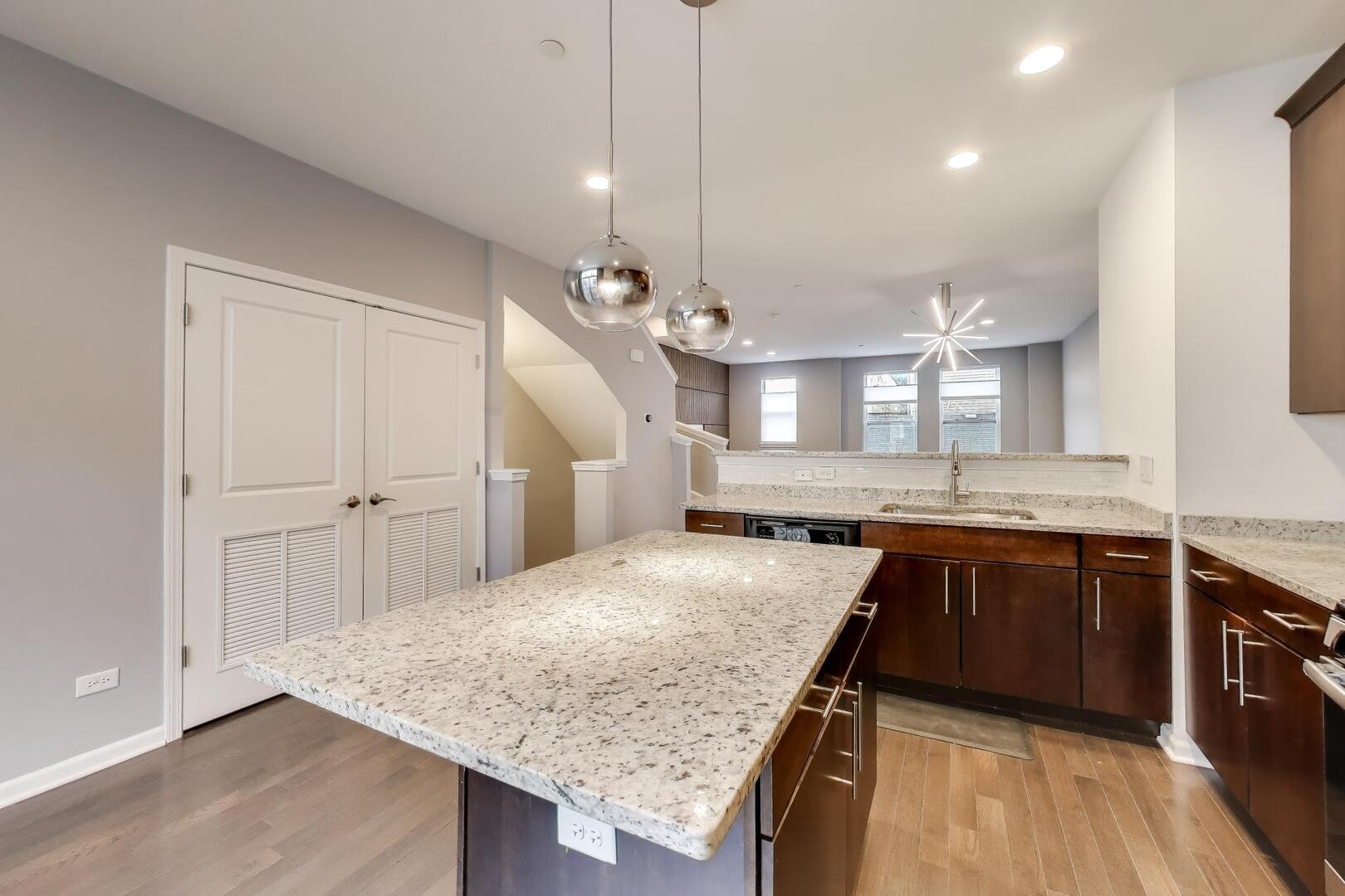 3625 South Morgan Street, Unit C Chicago, IL 60609 - Photo 15 of 44 a kitchen with granite countertop kitchen island sink stove and wooden floor
