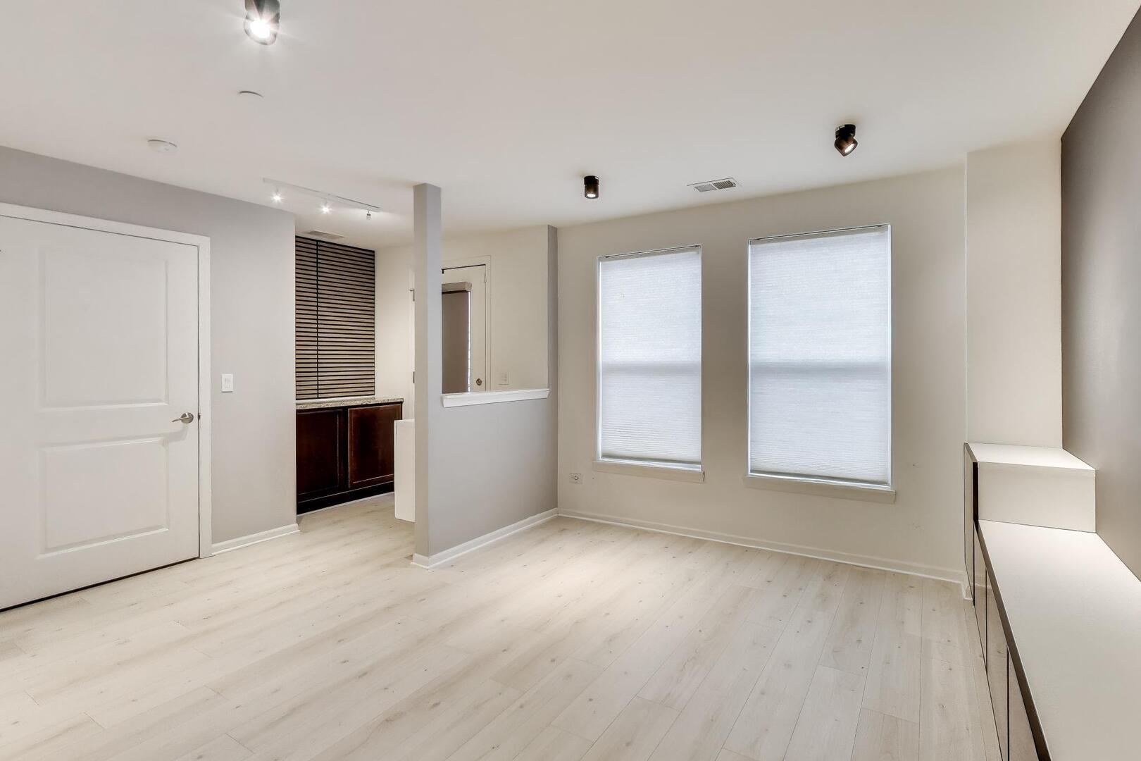 3625 South Morgan Street, Unit C Chicago, IL 60609 - Photo 8 of 44 a view of an empty room with a window and wooden floor
