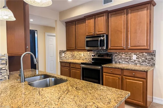 a kitchen with a stove a sink and a microwave