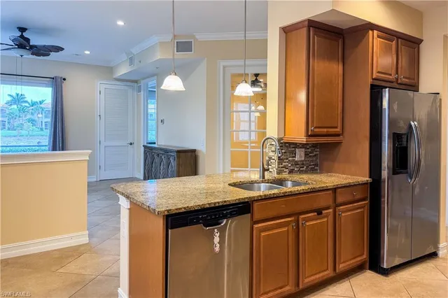 a kitchen with stainless steel appliances granite countertop a sink stove and refrigerator