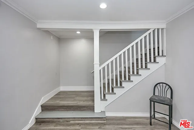 a view of entryway and hall with wooden floor