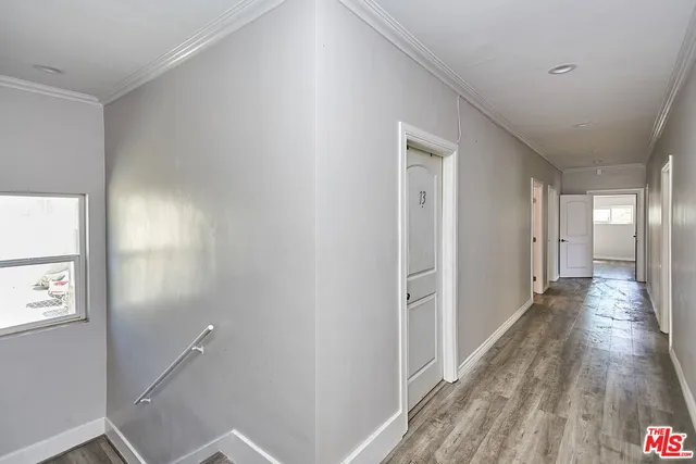 a view of a hallway with wooden floor