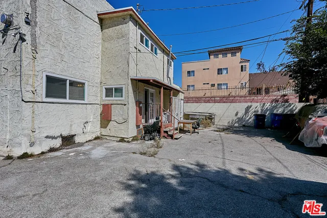 a view of a house with a patio and a car parked in front of it