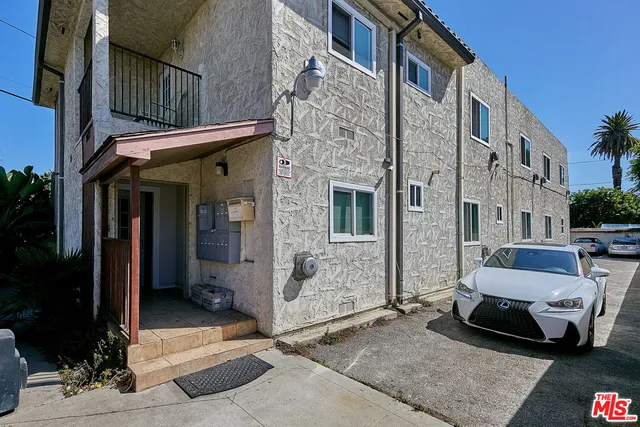 a car parked in front of a brick building