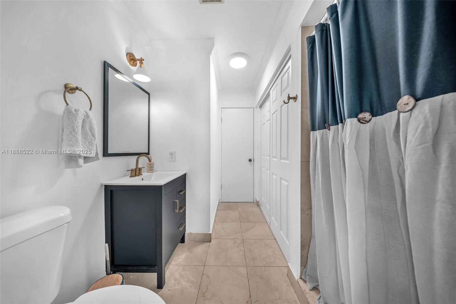 11006 Southwest 138th Place Miami, FL 33186 - Photo 13 of 47 a bathroom with a toilet sink and mirror