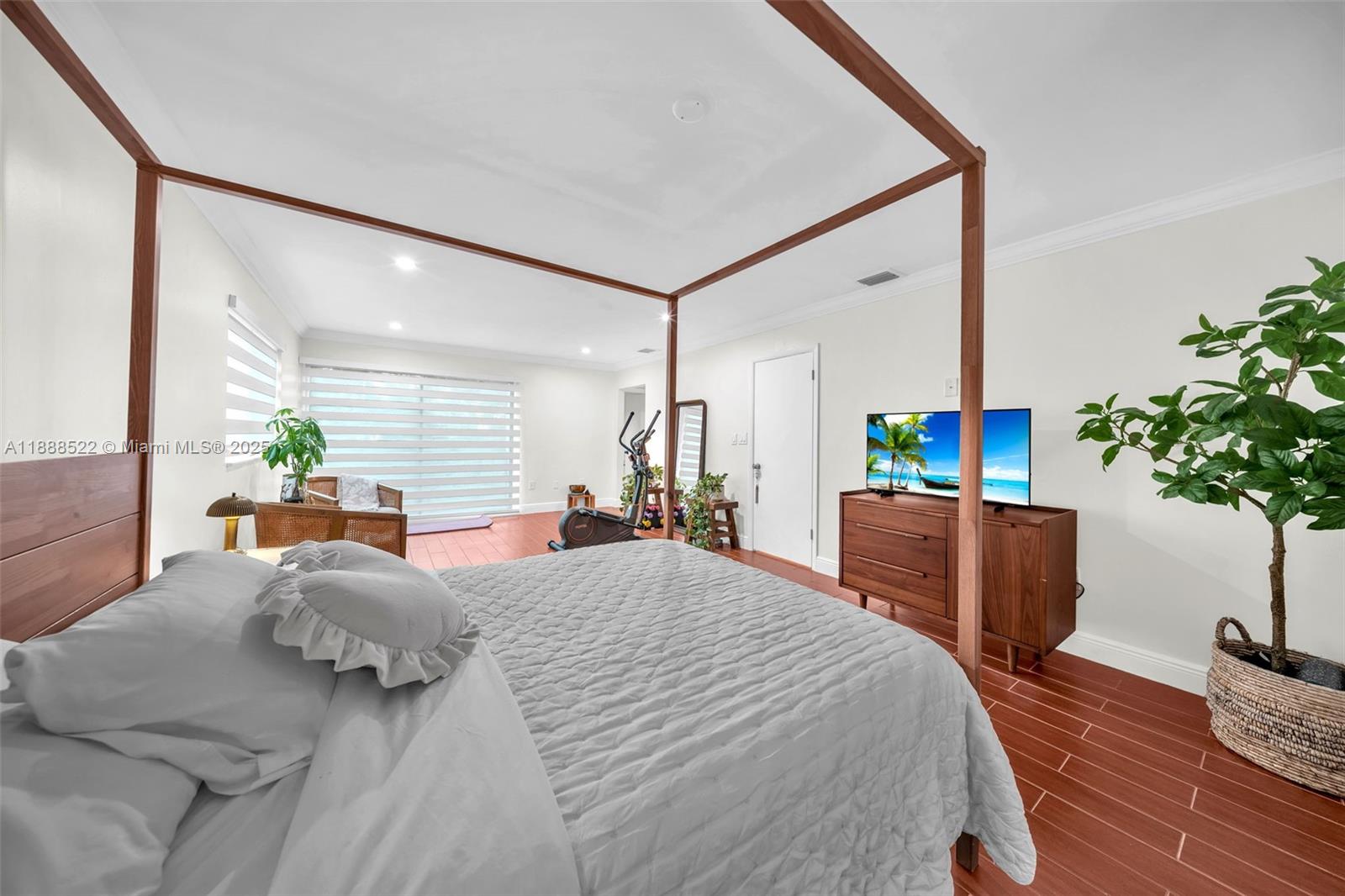 11006 Southwest 138th Place Miami, FL 33186 - Photo 26 of 47 a bedroom with a large bed and a potted plant