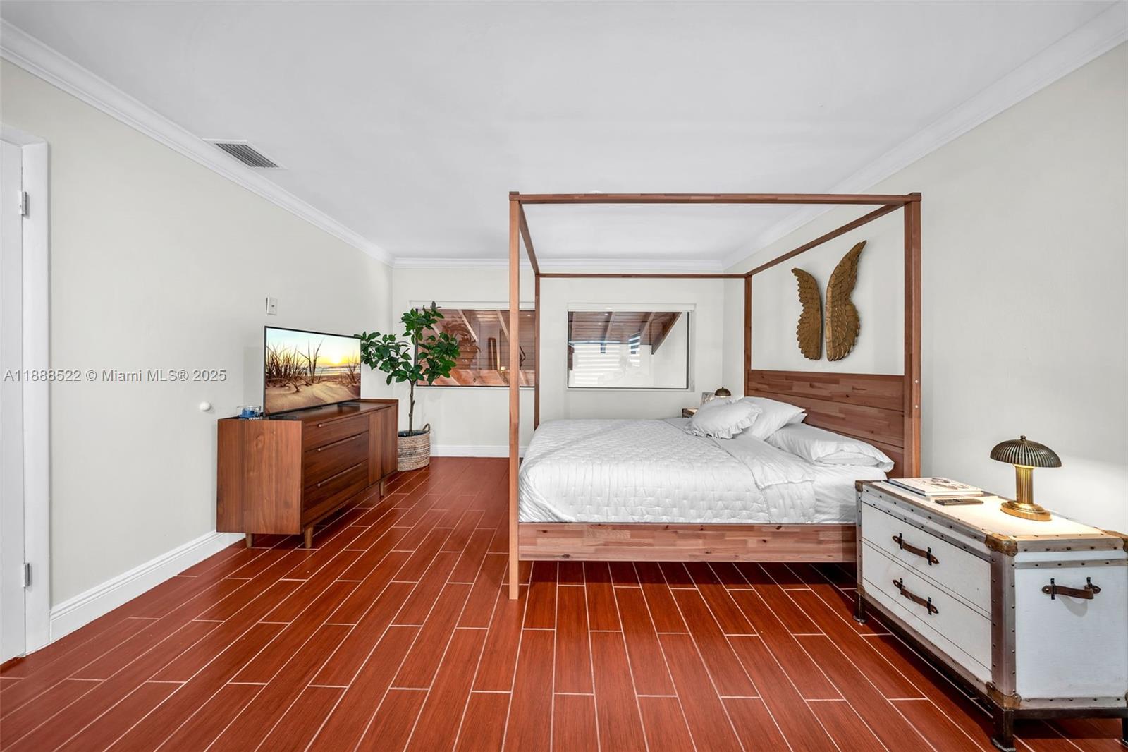 11006 Southwest 138th Place Miami, FL 33186 - Photo 27 of 47 a bedroom with a bed and wooden floor