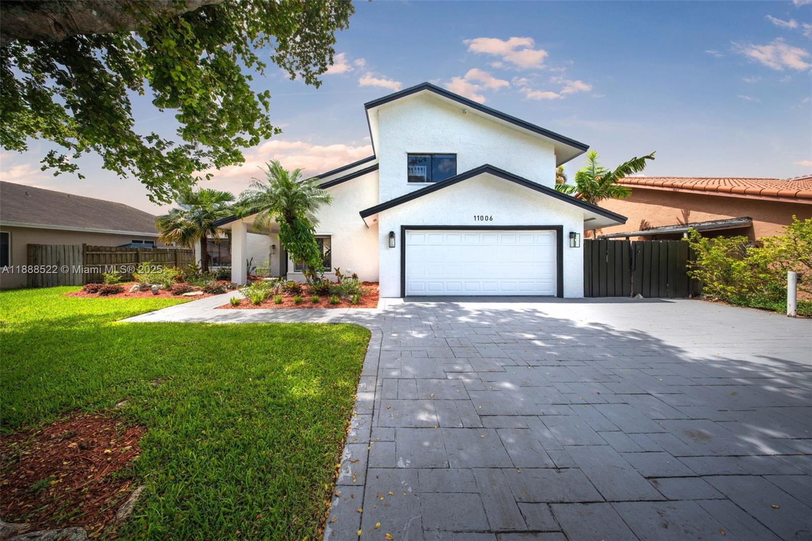 11006 Southwest 138th Place Miami, FL 33186 - Photo 3 of 47 a front view of a house with garden
