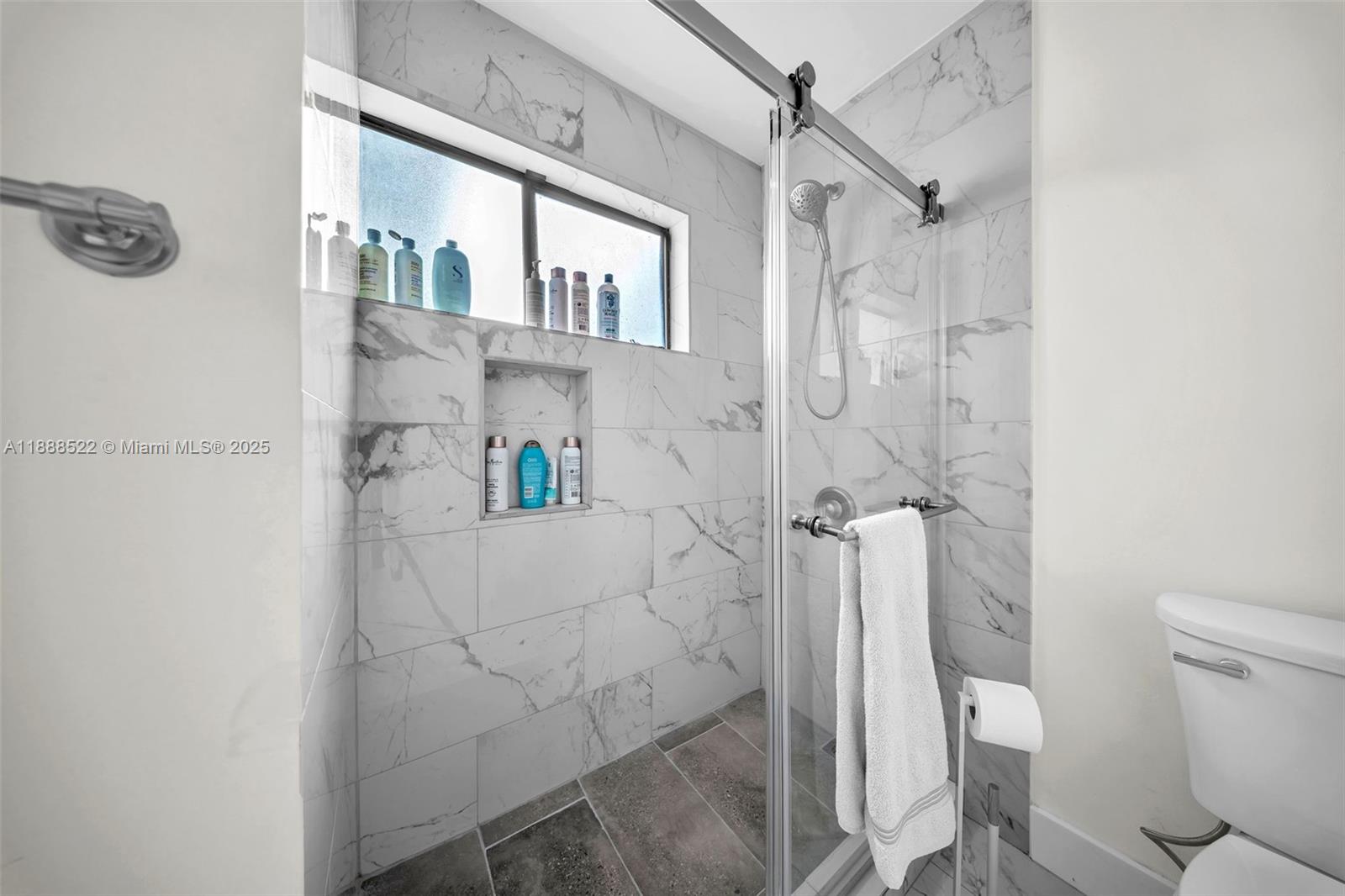11006 Southwest 138th Place Miami, FL 33186 - Photo 32 of 47 a bathroom with a shower a toilet and sink