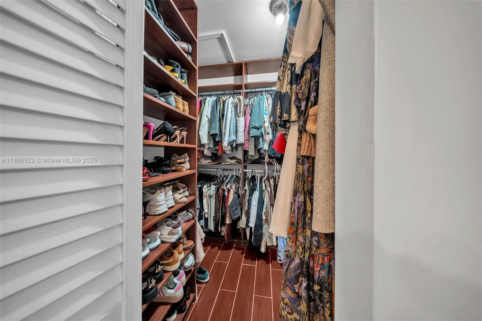 11006 Southwest 138th Place Miami, FL 33186 - Photo 33 of 47 a view of walk in closet with clothes and shoes