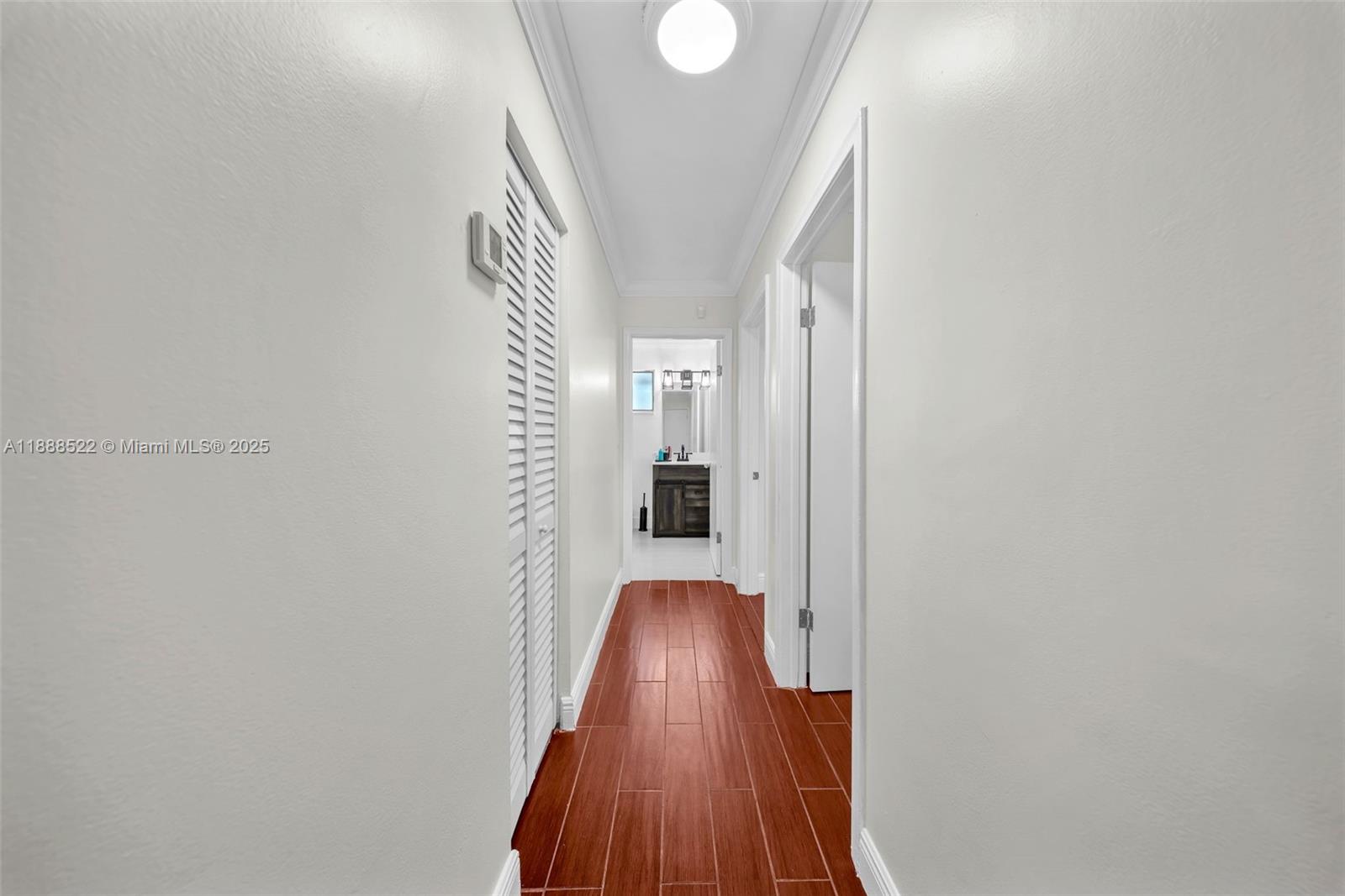 11006 Southwest 138th Place Miami, FL 33186 - Photo 38 of 47 a view of a hallway with wooden floor and staircase