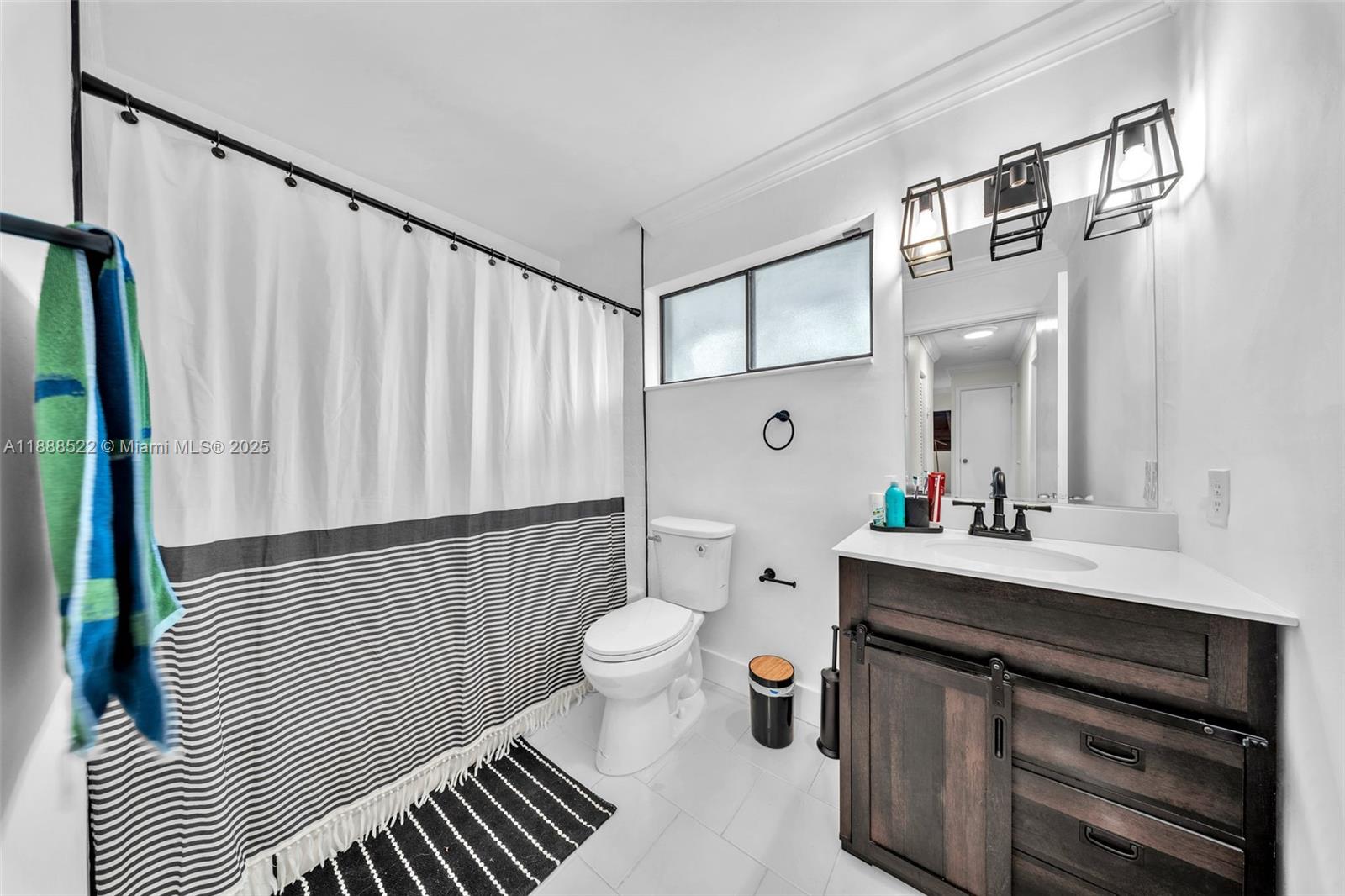 11006 Southwest 138th Place Miami, FL 33186 - Photo 39 of 47 a bathroom with a sink a toilet and a mirror