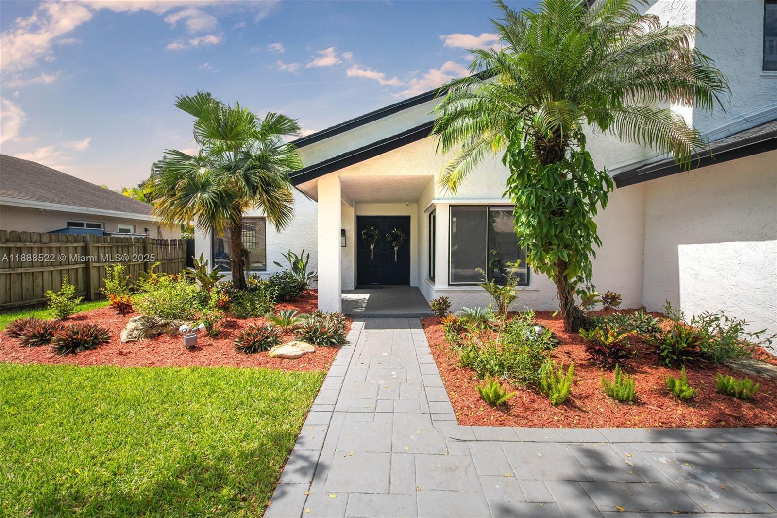 11006 Southwest 138th Place Miami, FL 33186 - Photo 5 of 47 a view of a house with a yard and potted plants