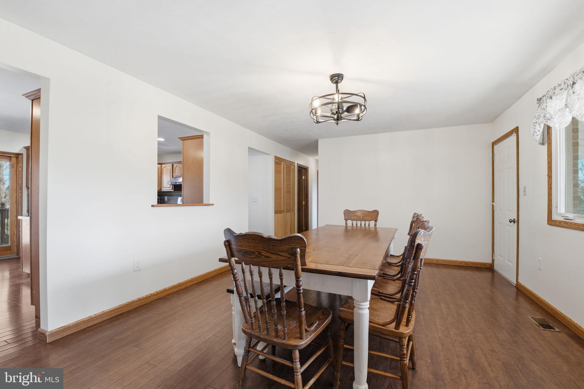 6501 Fair School Road Glen Rock, PA 17327 - Photo 5 of 43 a view of a dining room with furniture wooden floor and a chandelier