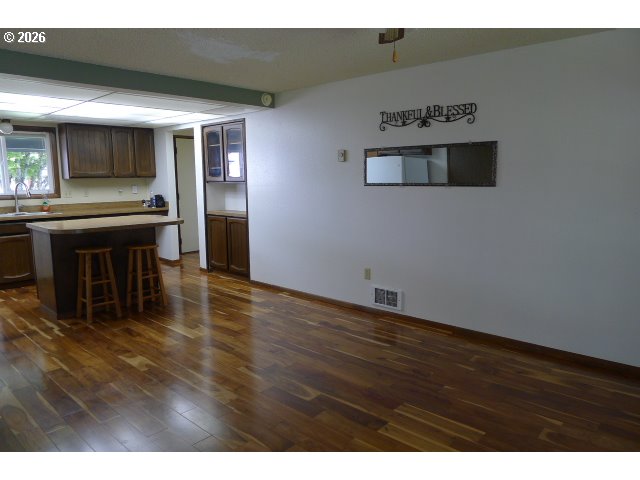 412 Camellia Court Reedsport, OR 97467 - Photo 18 of 48 a view of kitchen with furniture and wooden floor