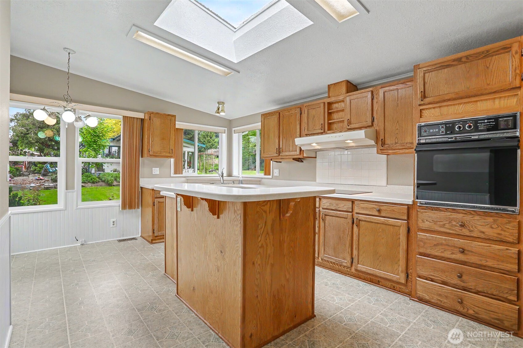 905 243rd Street Southwest Bothell, WA 98021 - Photo 4 of 37 a kitchen with stainless steel appliances granite countertop a stove a sink and a microwave