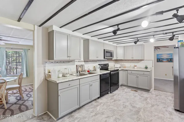 a bedroom with a dresser and a chandelier