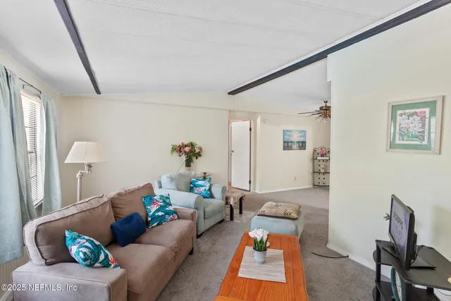 a bedroom with a bed and a lamp on dresser