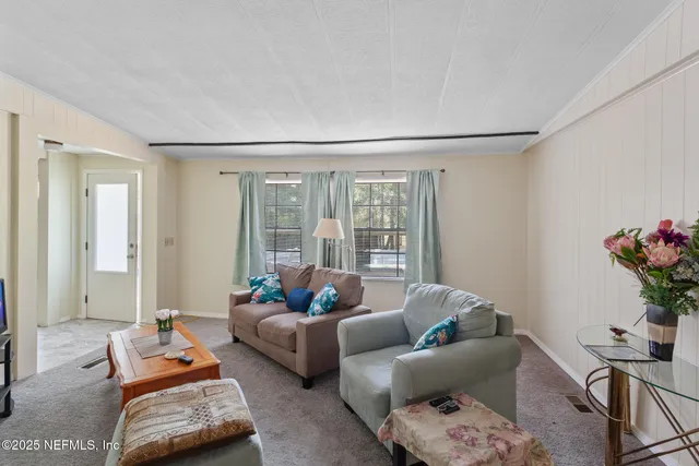 a bed with a bed and a painting on the wall