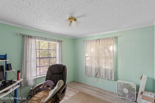 a view of a backyard with plants and a patio