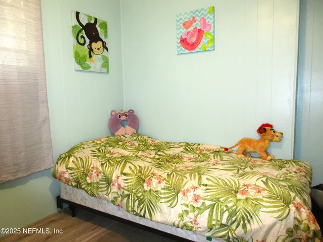 a view of a house with backyard and a tree