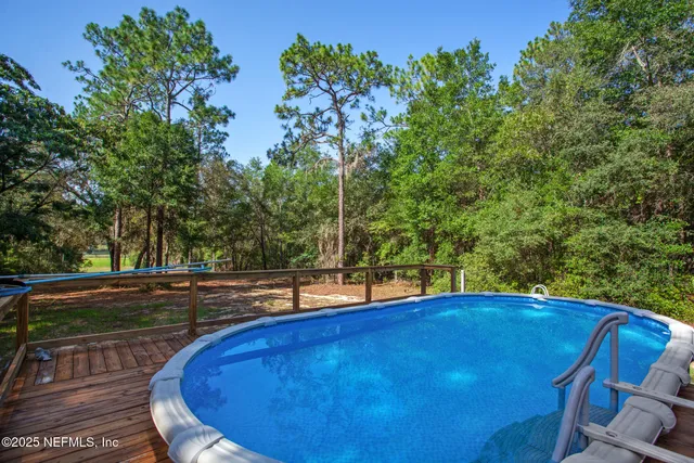 a view of swimming pool with a yard