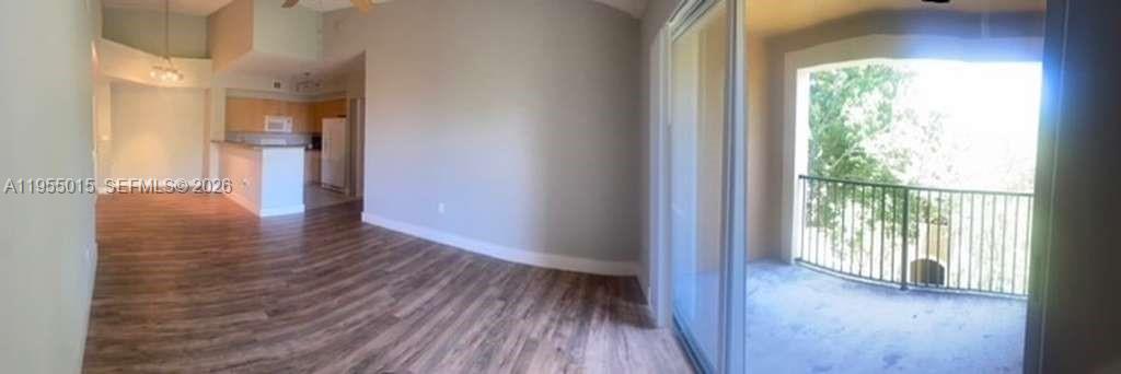 7930 North Nob Hill Road, Unit 304 Tamarac, FL 33321 - Photo 13 of 30 a view of hallway with wooden floor and a large window