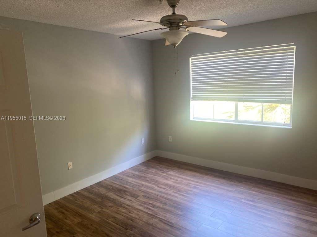 7930 North Nob Hill Road, Unit 304 Tamarac, FL 33321 - Photo 19 of 30 wooden floor in an empty room with a window