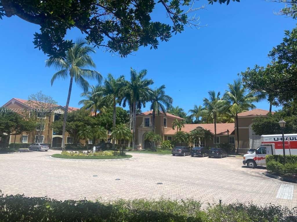 7930 North Nob Hill Road, Unit 304 Tamarac, FL 33321 - Photo 2 of 30 a palm tree in front of a house with a yard