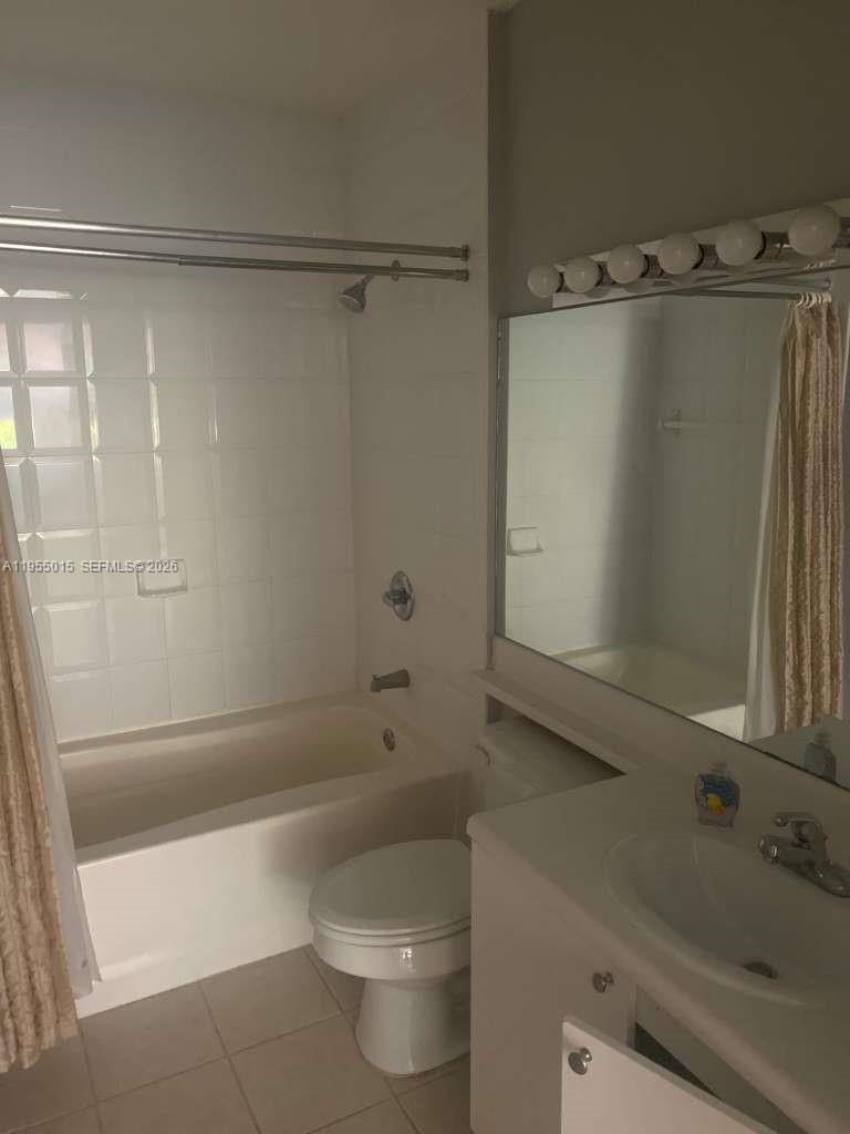 7930 North Nob Hill Road, Unit 304 Tamarac, FL 33321 - Photo 21 of 30 a bathroom with a sink a toilet and shower