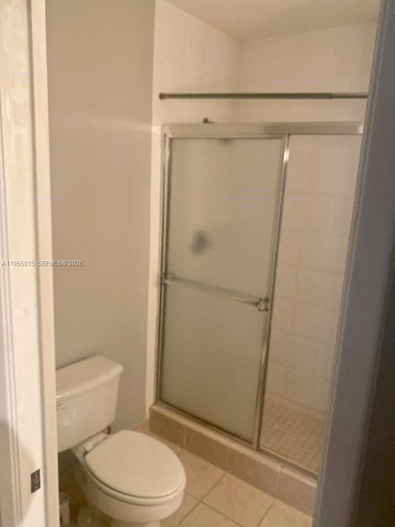 7930 North Nob Hill Road, Unit 304 Tamarac, FL 33321 - Photo 22 of 30 a white toilet sitting next to a shower