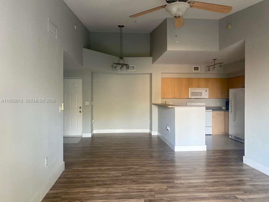 7930 North Nob Hill Road, Unit 304 Tamarac, FL 33321 - Photo 4 of 30 a view of a kitchen with a sink and a refrigerator