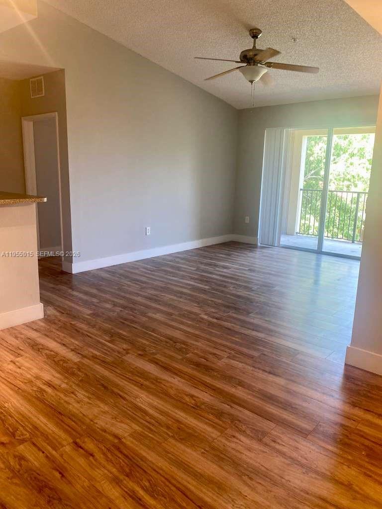 7930 North Nob Hill Road, Unit 304 Tamarac, FL 33321 - Photo 6 of 30 a view of empty room with wooden floor and fan