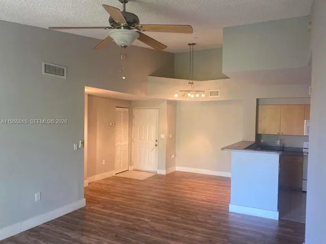 a room with wooden floor and window