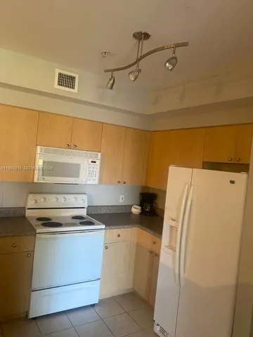 a kitchen with a refrigerator and a stove