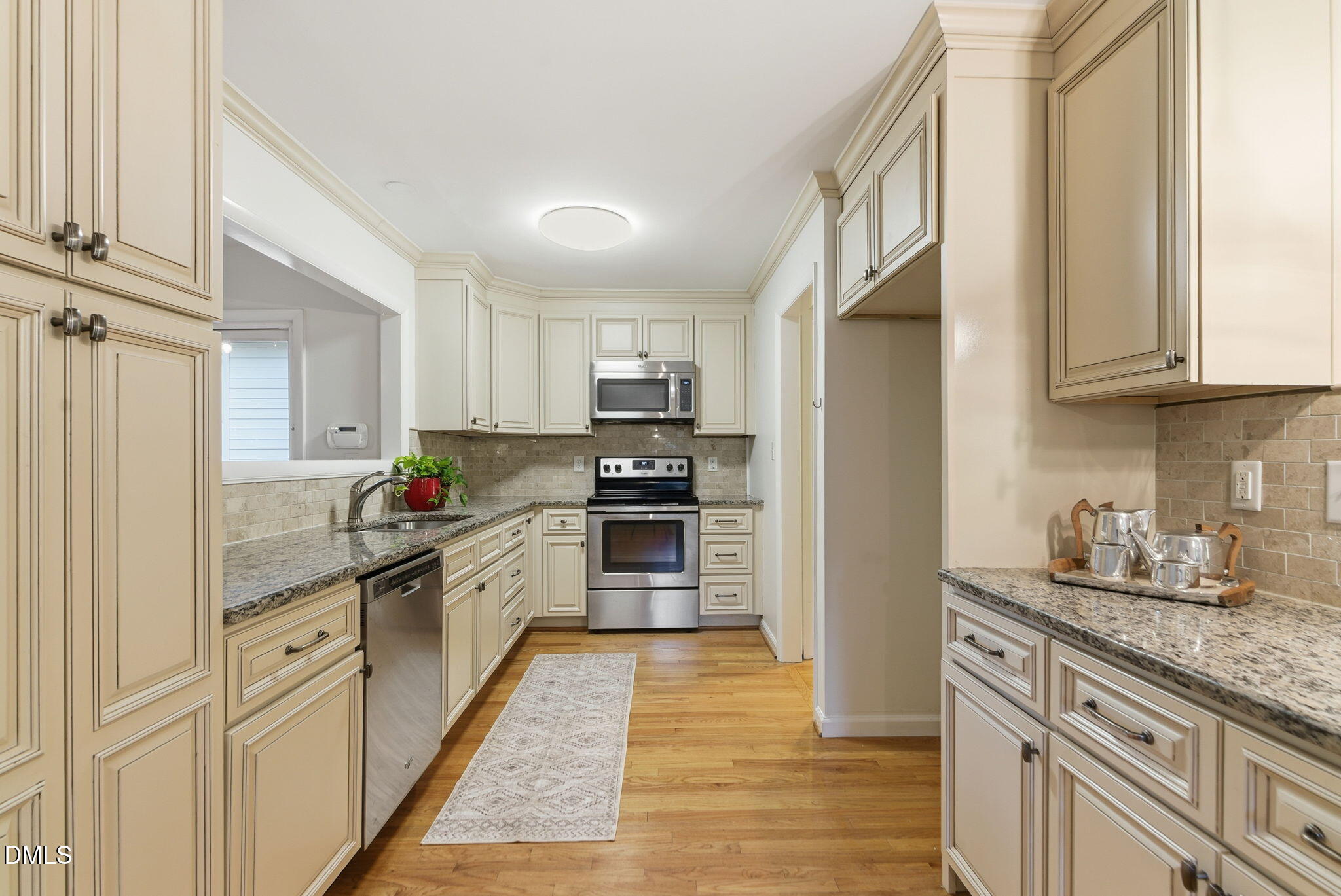 531 West Cornwall Road Cary, NC 27511 - Photo 11 of 77 a kitchen with granite countertop a refrigerator stove top oven and sink