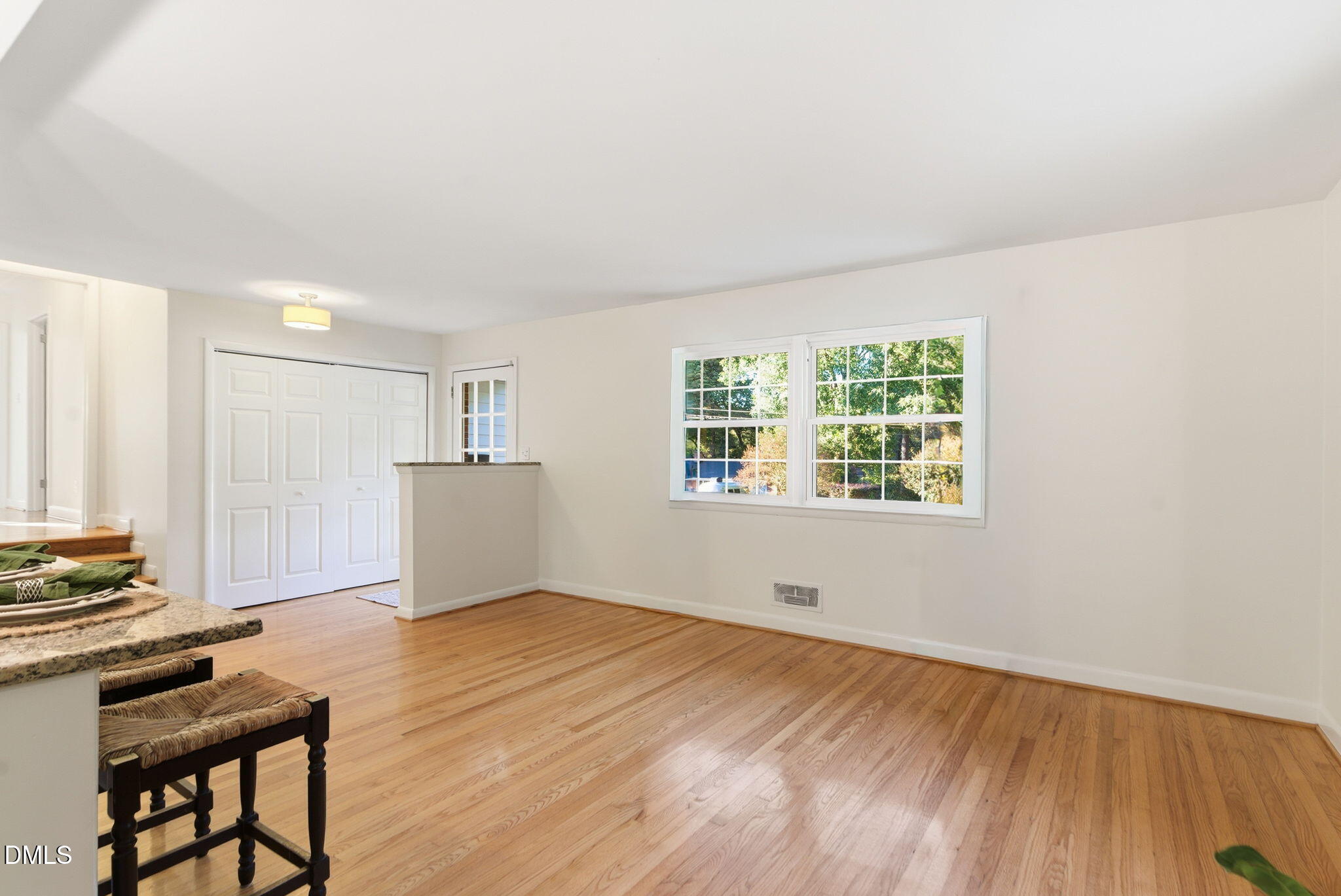 531 West Cornwall Road Cary, NC 27511 - Photo 13 of 77 a view of an empty room with wooden floor and a window