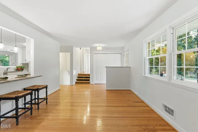 a kitchen with granite countertop white cabinets stainless steel appliances and potted plant