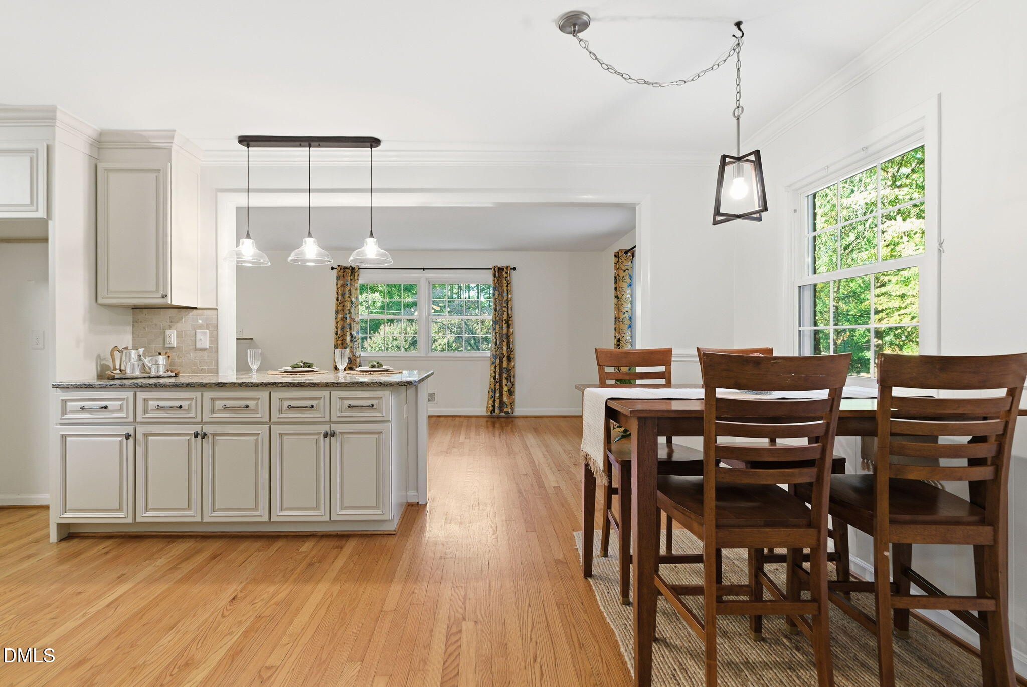 531 West Cornwall Road Cary, NC 27511 - Photo 24 of 77 a kitchen with stainless steel appliances granite countertop a stove a sink dishwasher a dining table and chairs with wooden floor
